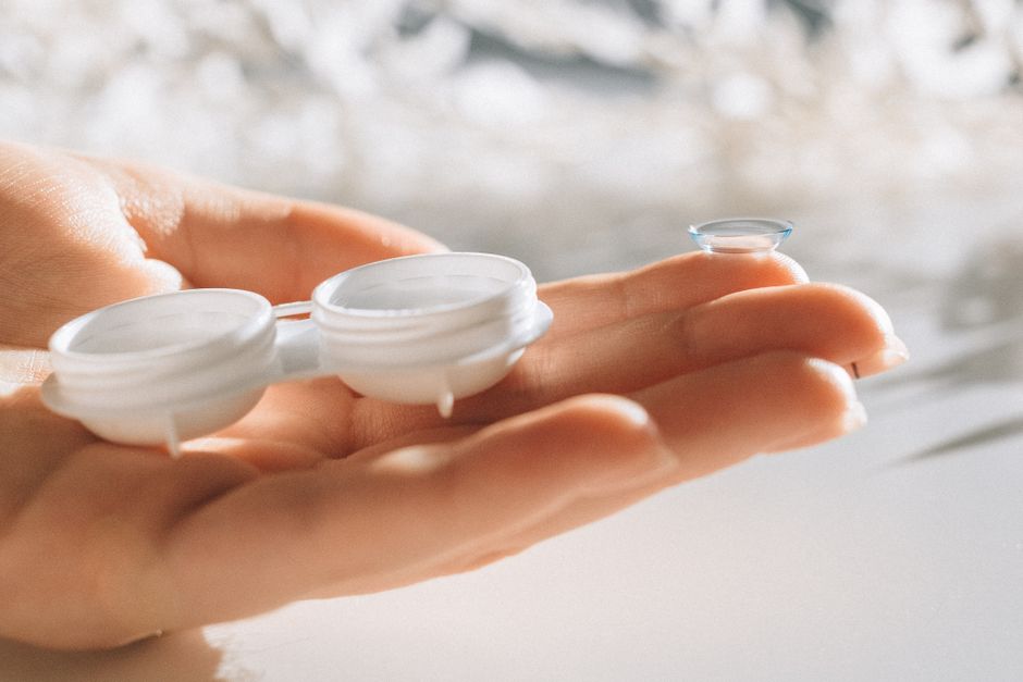 Contact lens close-up on a fingertip.