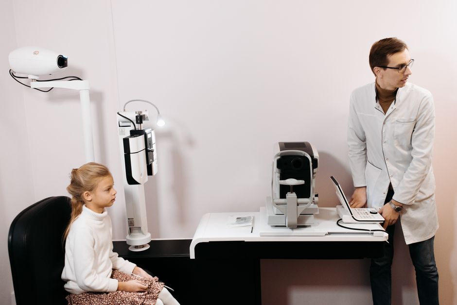 Optometrist examining a patient's eyes.